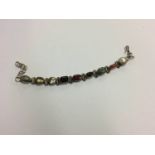 An Indian silver coloured bracelet, set with semi-precious and other stones