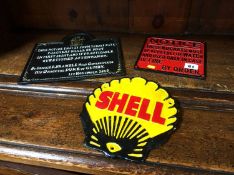 Three cast metal signs