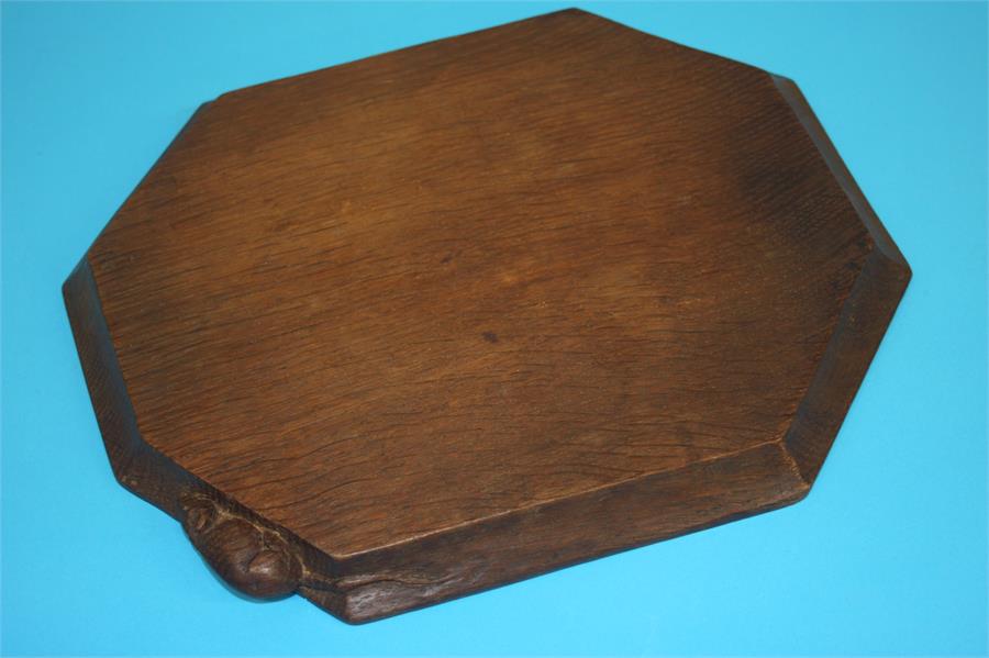 A Robert 'Mouseman' Thompson of Kilburn dark oak octagonal cheeseboard. 30 cm wide