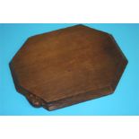 A Robert 'Mouseman' Thompson of Kilburn dark oak octagonal cheeseboard. 30 cm wide