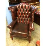 An Oxblood Chesterfield high back armchair