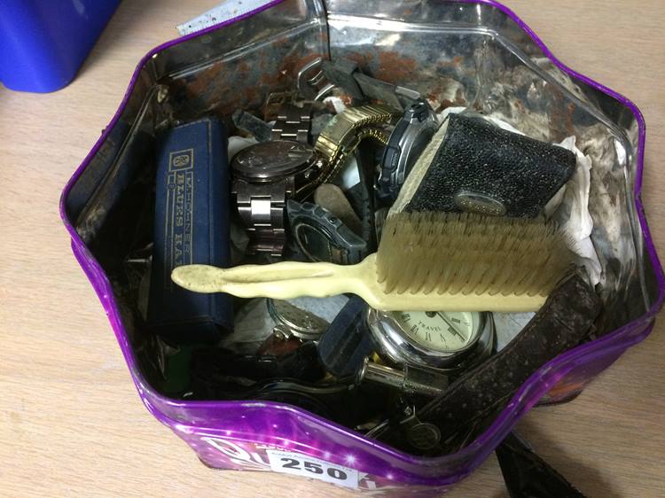 Tin containing various watches