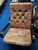 A button back tan leather swivel chair