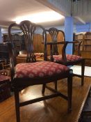 A set of reproduction mahogany chairs comprising four single and two carvers