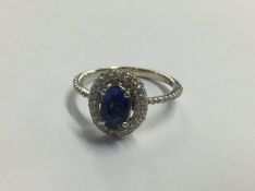 White metal sapphire coloured stone mounted ring, stamped '750'