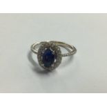White metal sapphire coloured stone mounted ring, stamped '750'