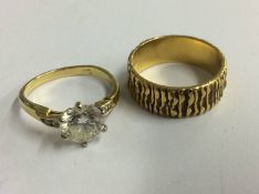 A ring stamped 750 and one other