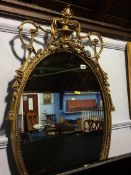 Ornate gilt oval mirror, 109cm height