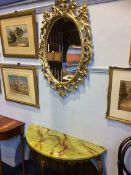 A gilt oval mirror and console table