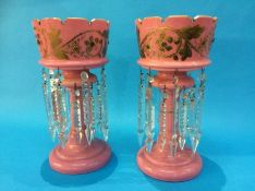 A pair of Victorian pink glass lustres with gilt foliate decoration