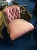 A pink upholstered and Bergere tub chair