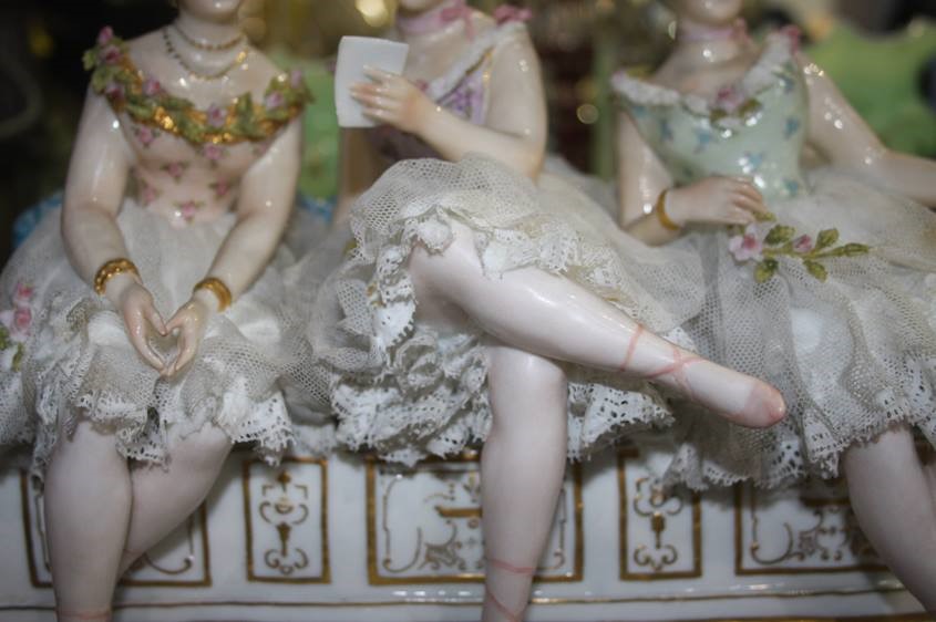 A late 19th century Continental porcelain group of three young Ladies seated on a bench, under a - Image 4 of 8