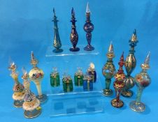 A Collection of nine decorative glass Bohemian style scent bottles, all decorated with enamels and