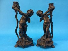 A pair of Cherub candlesticks