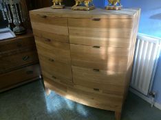 A modern Barker and Stonehouse 'Navajos' bow front chest of drawers with six short drawers and one