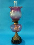 A Duplex oil lamp with pale purple reservoir and shade