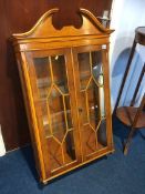 A yew wood glazed wall cabinet