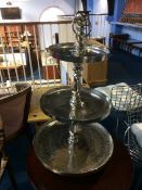 A silver coloured three tier graduating cake stand