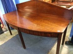 A mahogany bow front serving table