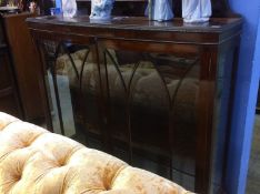 A mahogany bow front china cabinet