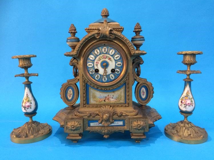 A French gilt clock with 8 day movement and strike action, set with Sevres style porcelain dial