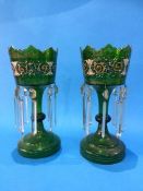 A pair of Victorian green glass and painted enamelled lustres, with clear glass drops. 30 cm high