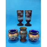 A pair of red acid etched Bohemian glass goblets, a pair of blue glass and enamelled vases and a
