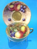 A Royal Worcester cup and saucer by Maybury and Roberts, decorated with peaches, blackberries and