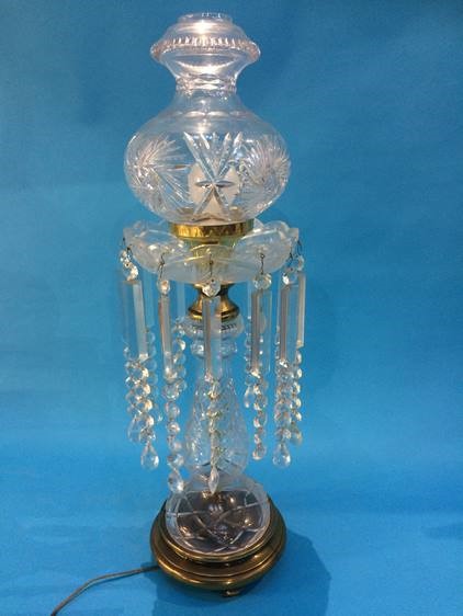 A tall cut glass table lamp with facet cut drops. 70 cm high