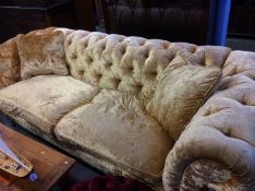 A Delcor crushed velvet gold Chesterfield settee and matching circular footstool