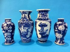 A pair of Chinese blue and white vases decorated with prunus leaves, marks in underglaze blue, and