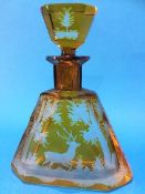 A Bohemian amber glass triangular shaped decanter, with etched decoration of a deer running