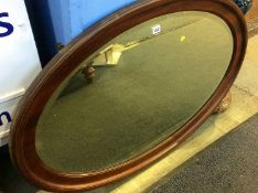 A large mahogany oval mirror