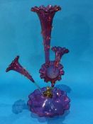 A Victorian Cranberry glass epergne with four glass trumpets