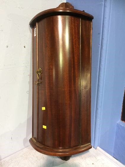 A small mahogany hanging corner cabinet