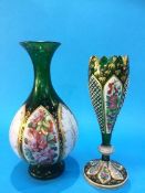 A Bohemian green glass spill vase with enamelled panels decorated with flowers, 23 cm high and