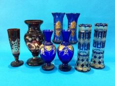 Three pairs of blue glass vases and two cranberry coloured etched glass vases