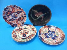 A Japanese Cloisonné dish decorated with carp and three Imari wall plaques, all 30 cm wide (