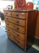 A 19th century mahogany chest of drawers with two short and four long graduated drawers, supported