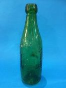 A green glass bottle 'Darlington Bottling and Mineral Water Co. Ltd'