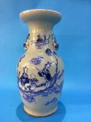 A Chinese vase on a pale sage ground decorated with figures and having lion handles. 42 cm high