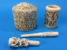 A heavily carved ivory box, two cigarette holders etc.
