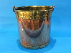 A copper and brass circular log/coal bucket