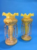 A pair of Victorian yellow and white glass lustres, with gilt decoration