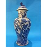 A Chinese blue and white vase of baluster shape, the lid surmounted with a lion, the whole decorated