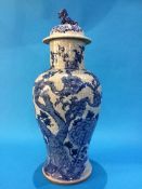 A Chinese blue and white vase of baluster shape, the lid surmounted with a lion, the whole decorated