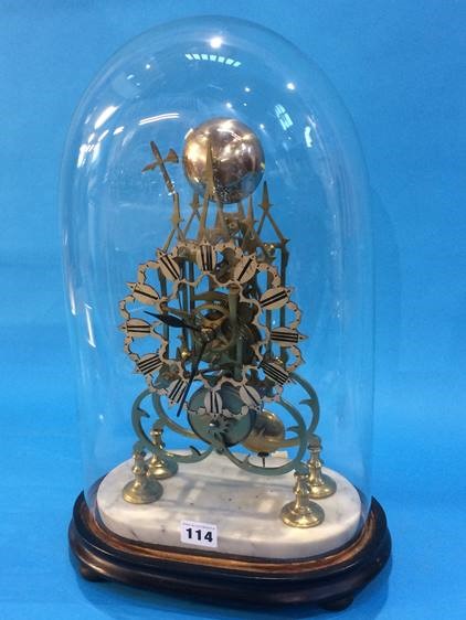 A brass Skeleton clock with silvered dial and strike action, under a glass dome. 35 cm high