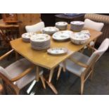 A pale oak Ercol style refectory table and four chairs