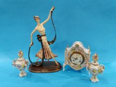 A porcelain clock, a pair of garnitures and a Deco style figure