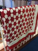 A red star and white octagonal pattern Durham quilt, with white reverse